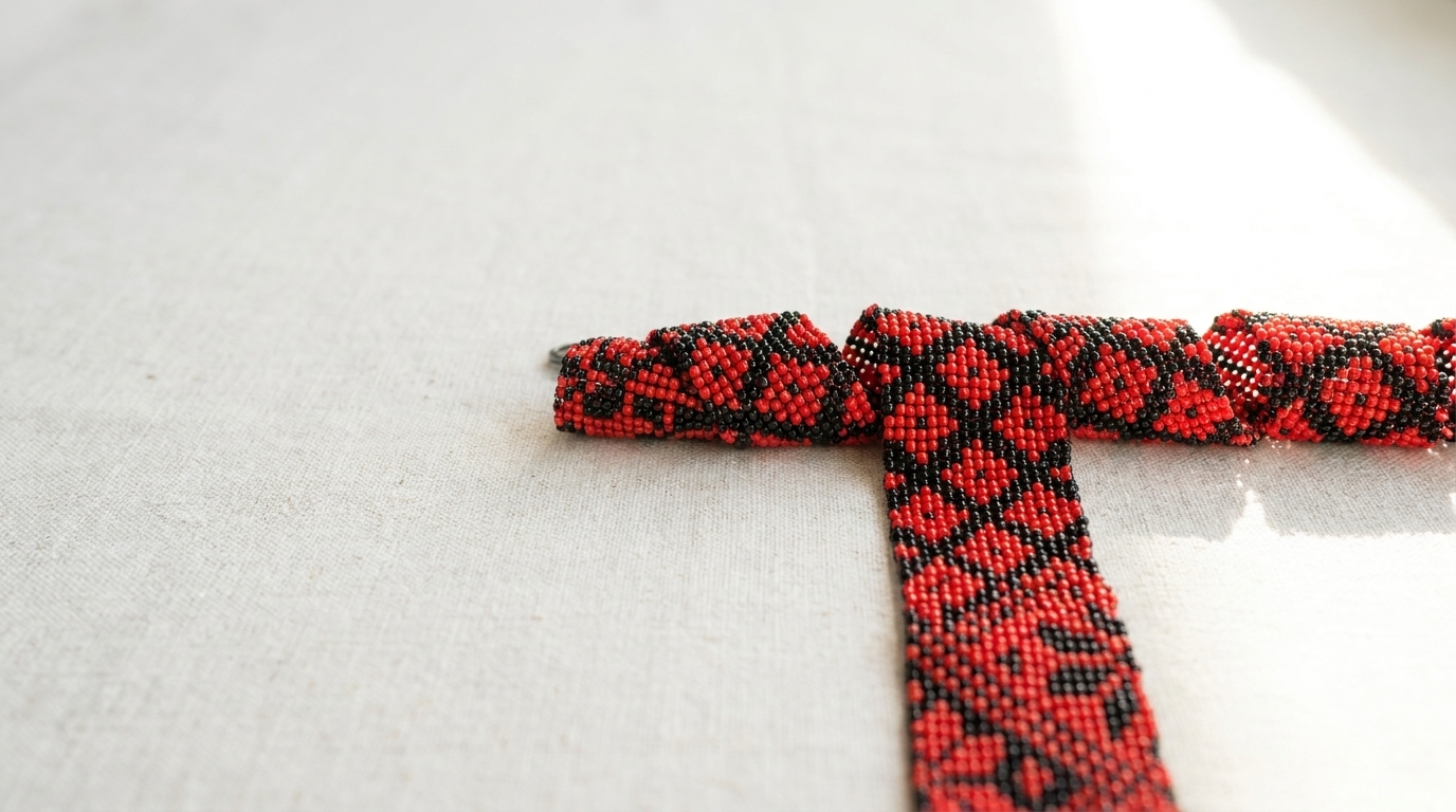 Traditional red and black beaded bracelet on natural linen.